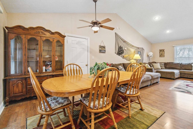 dining area with hardwood / wood-style flooring, ceiling fan, and vaulted ceiling