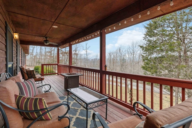 wooden terrace featuring ceiling fan