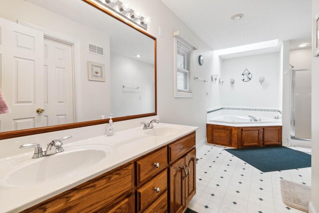 bathroom featuring vanity and separate shower and tub