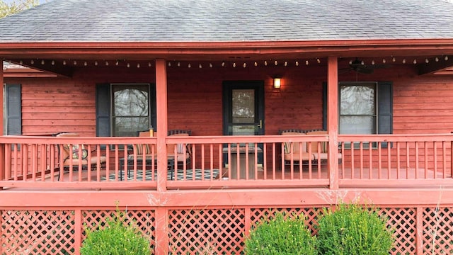 wooden terrace featuring ceiling fan and covered porch