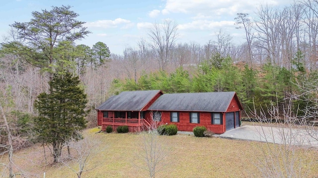 cabin with a garage and a front lawn