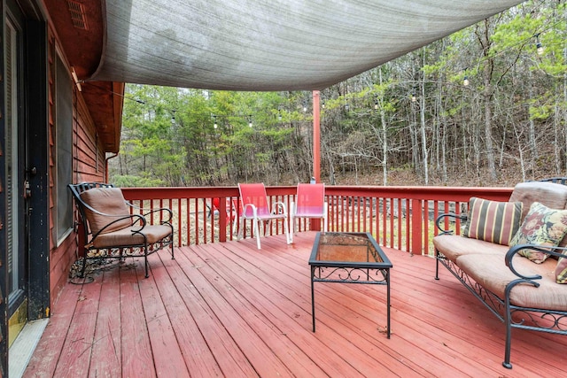 wooden terrace with an outdoor hangout area