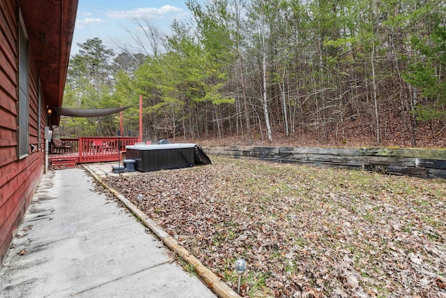 view of yard featuring a wooden deck and central AC