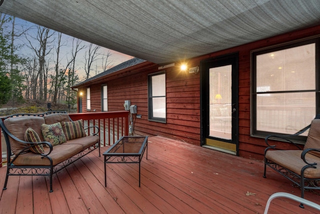 deck at dusk featuring outdoor lounge area