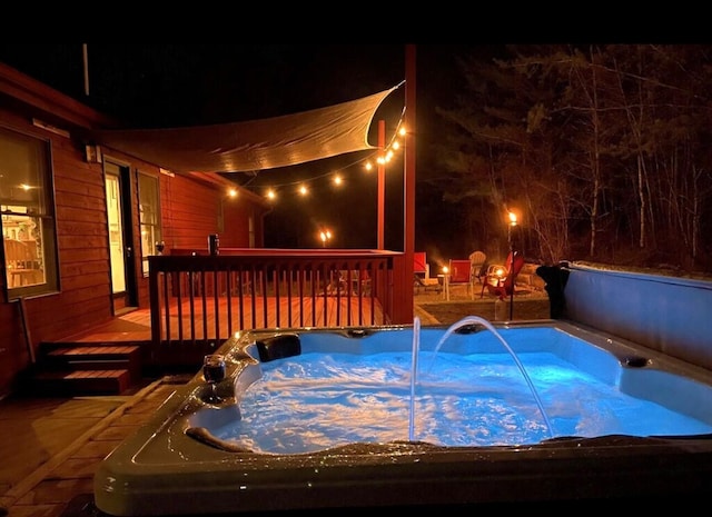 exterior space featuring a wooden deck and a hot tub