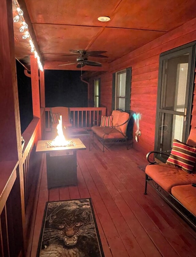 deck with ceiling fan and a fire pit