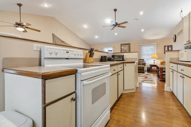 kitchen with white cabinetry, white appliances, vaulted ceiling, and light wood-type flooring