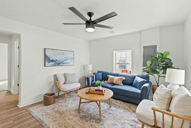 living room with ceiling fan and light wood-type flooring