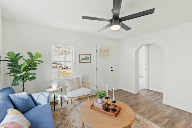 living room with wood-type flooring and ceiling fan