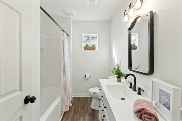 full bathroom featuring vanity, toilet, hardwood / wood-style floors, and shower / bath combo