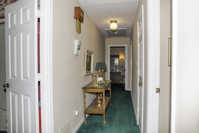 hallway with dark colored carpet