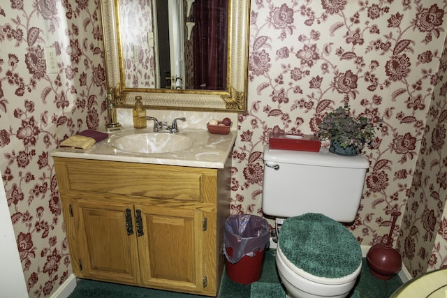 bathroom featuring vanity and toilet