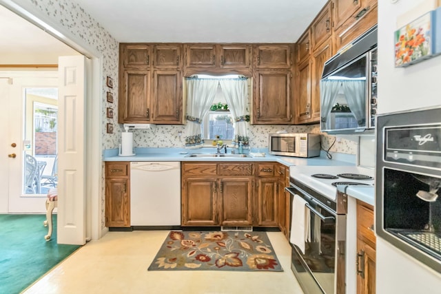 125 Thomas St, Somerset, KY 42503 - kitchen with a sink, wallpapered walls, brown cabinets, white appliances, and light countertops
