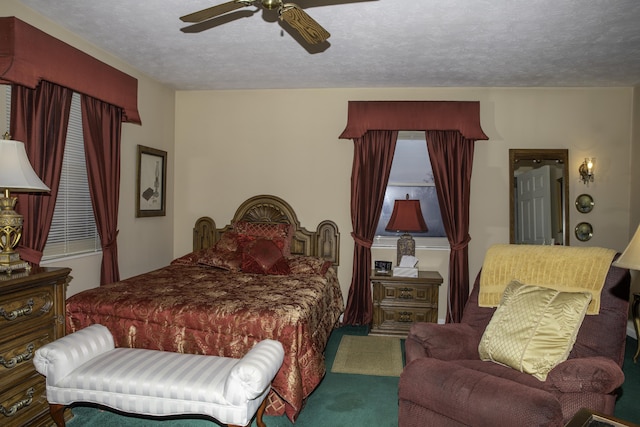 bedroom featuring ceiling fan, carpet floors, and a textured ceiling