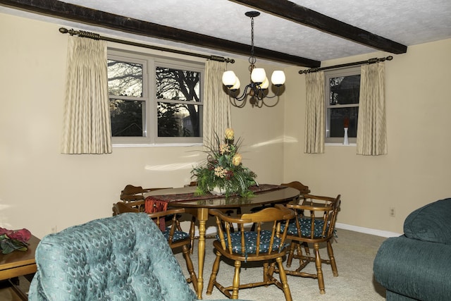 dining room featuring an inviting chandelier, beam ceiling, carpet floors, and a textured ceiling