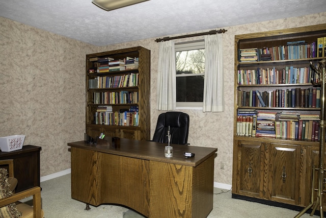 home office featuring light carpet and a textured ceiling