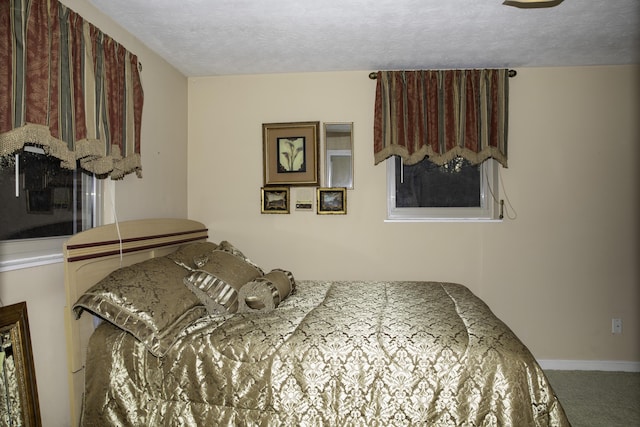 carpeted bedroom featuring a textured ceiling