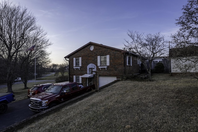 exterior space featuring a garage and a lawn