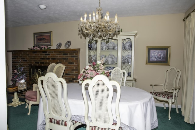 dining room with an inviting chandelier, a brick fireplace, a textured ceiling, and carpet