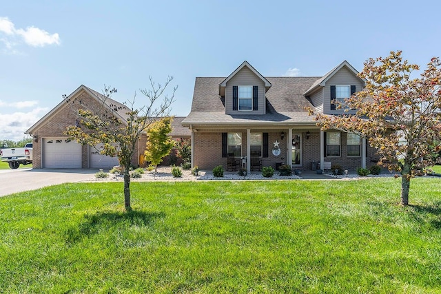 cape cod home featuring a porch, a garage, and a front lawn