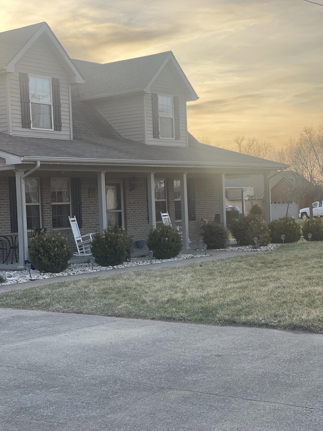 country-style home with a yard and a porch