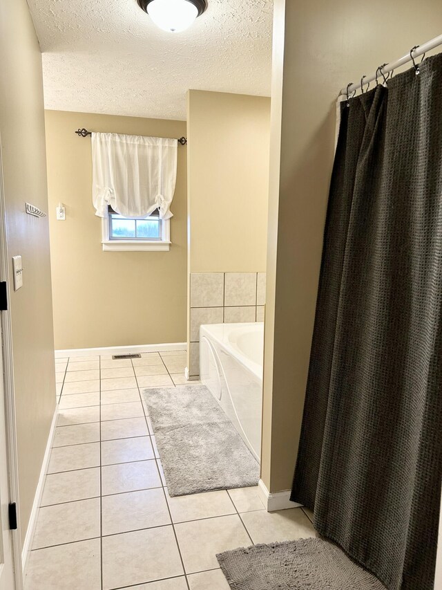 bathroom featuring a shower with shower curtain and tile patterned flooring