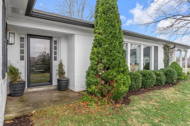 entrance to property with brick siding