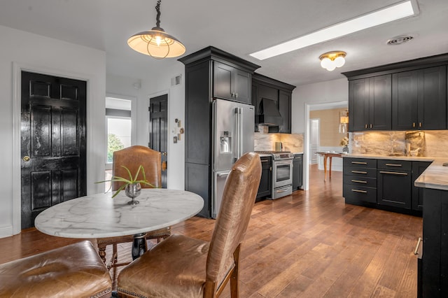 dining space featuring visible vents and hardwood / wood-style flooring