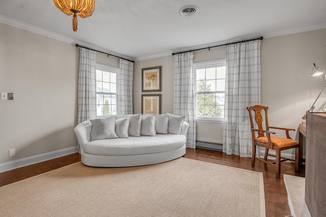 living area with visible vents, baseboard heating, ornamental molding, wood finished floors, and baseboards