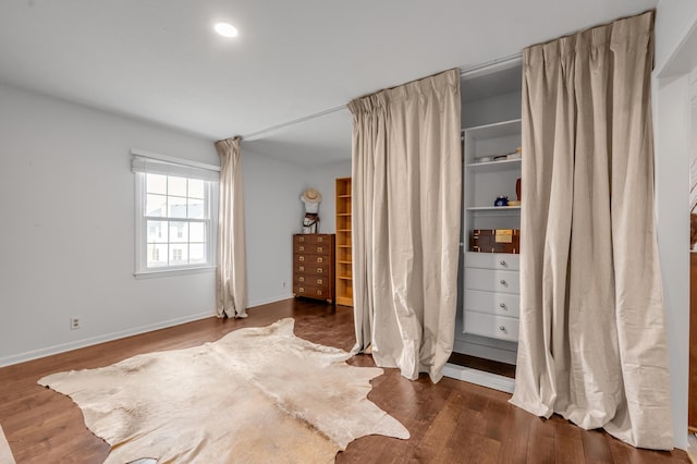 bedroom featuring baseboards and wood finished floors