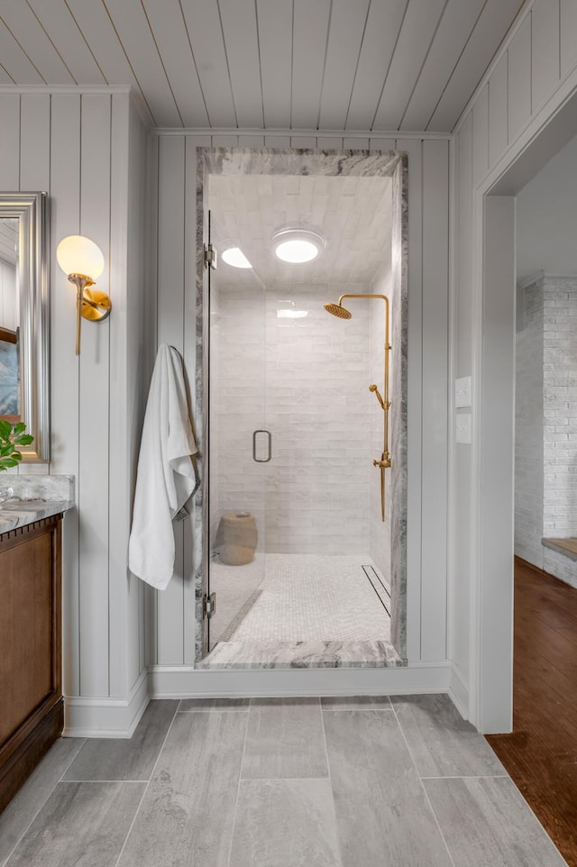 full bathroom with a shower stall and vanity