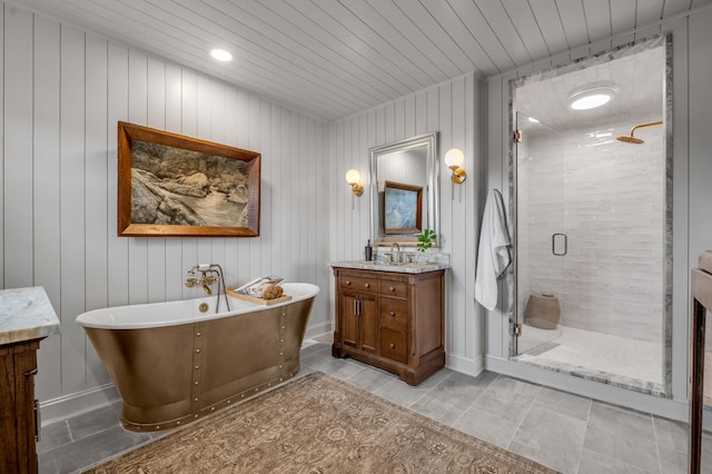 bathroom with baseboards, wooden ceiling, a soaking tub, vanity, and a shower stall