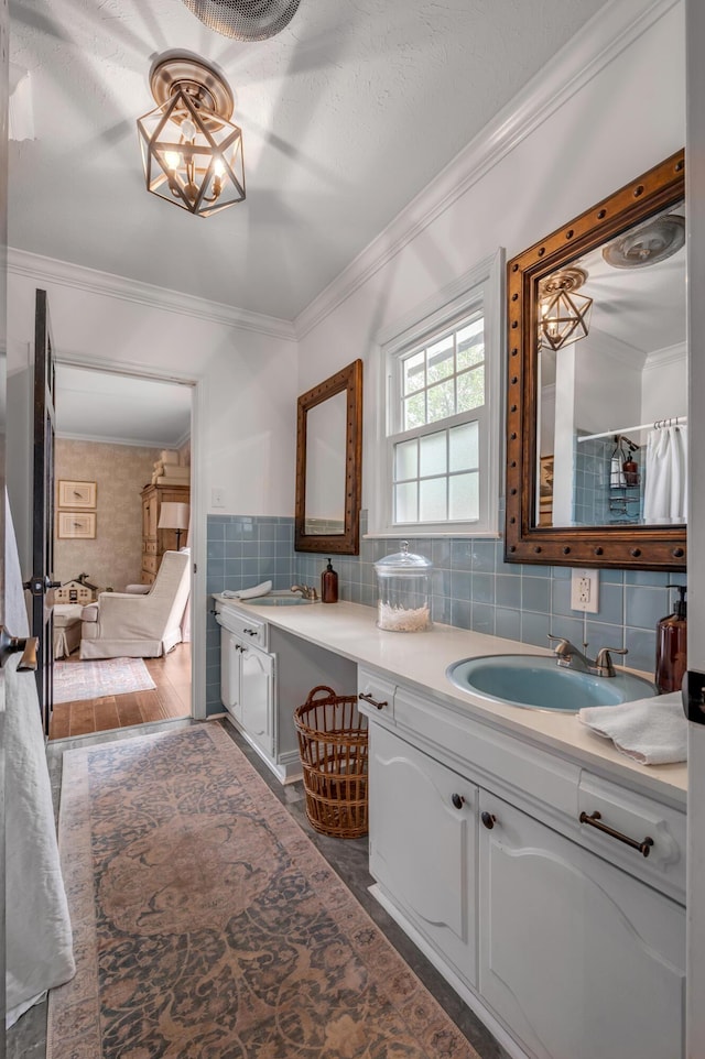 full bathroom featuring tasteful backsplash, ornamental molding, and vanity