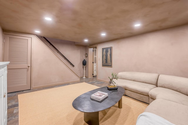 living area with baseboards, stairway, and recessed lighting