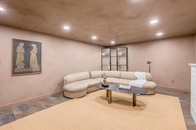 living room featuring baseboards and recessed lighting