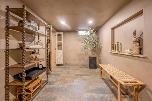 interior space with stone finish floor and baseboards