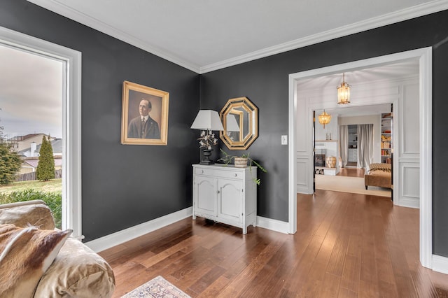 interior space featuring ornamental molding, dark wood finished floors, and baseboards