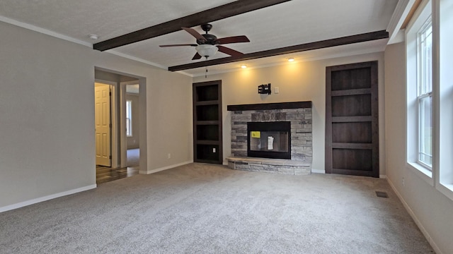 unfurnished living room featuring a fireplace, built in features, beamed ceiling, and carpet