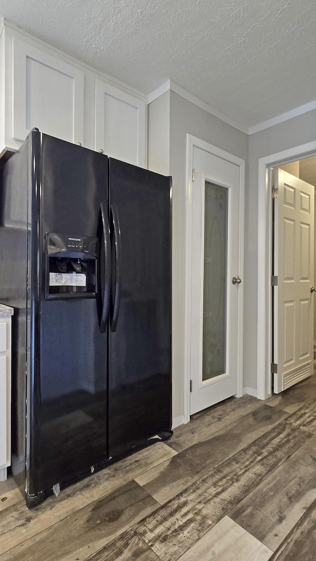 kitchen featuring white cabinets, dark hardwood / wood-style flooring, crown molding, a textured ceiling, and black refrigerator with ice dispenser