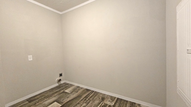 washroom featuring crown molding, electric dryer hookup, and dark hardwood / wood-style floors