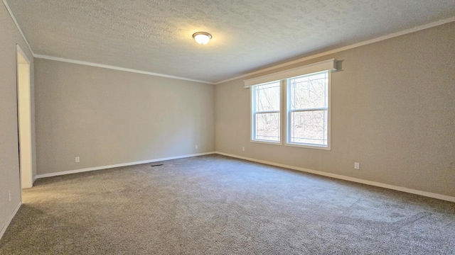 unfurnished room with ornamental molding, carpet, and a textured ceiling