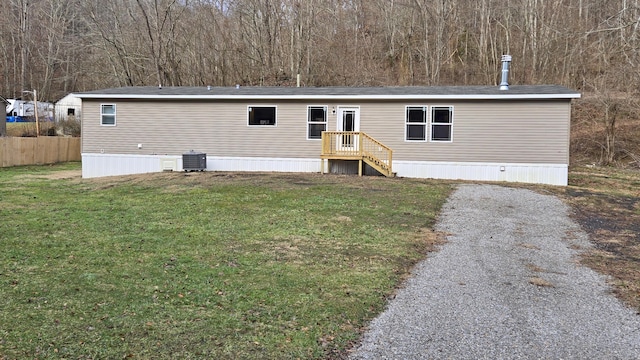 manufactured / mobile home with cooling unit and a front yard