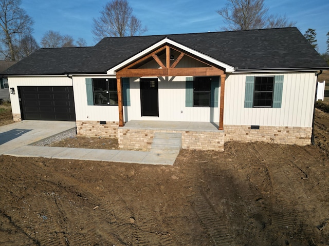 view of front of house featuring a garage and covered porch