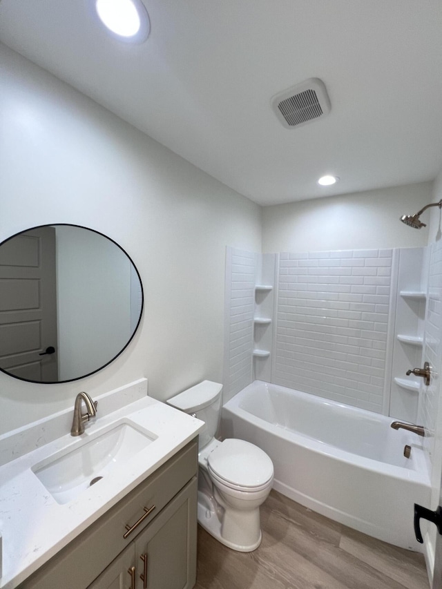 full bathroom with vanity, tub / shower combination, hardwood / wood-style floors, and toilet