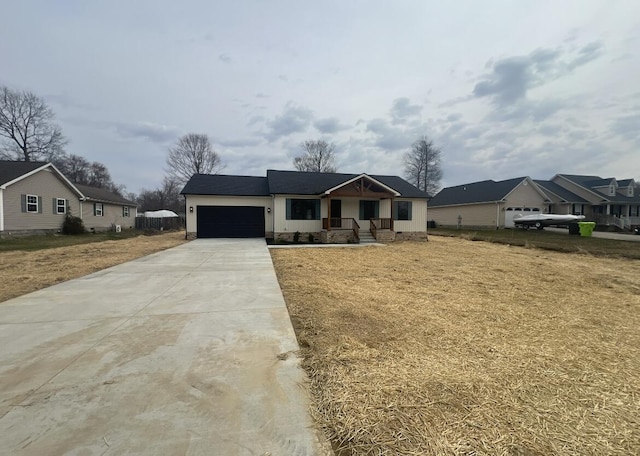 view of front of house featuring an attached garage, concrete driveway, and a front lawn