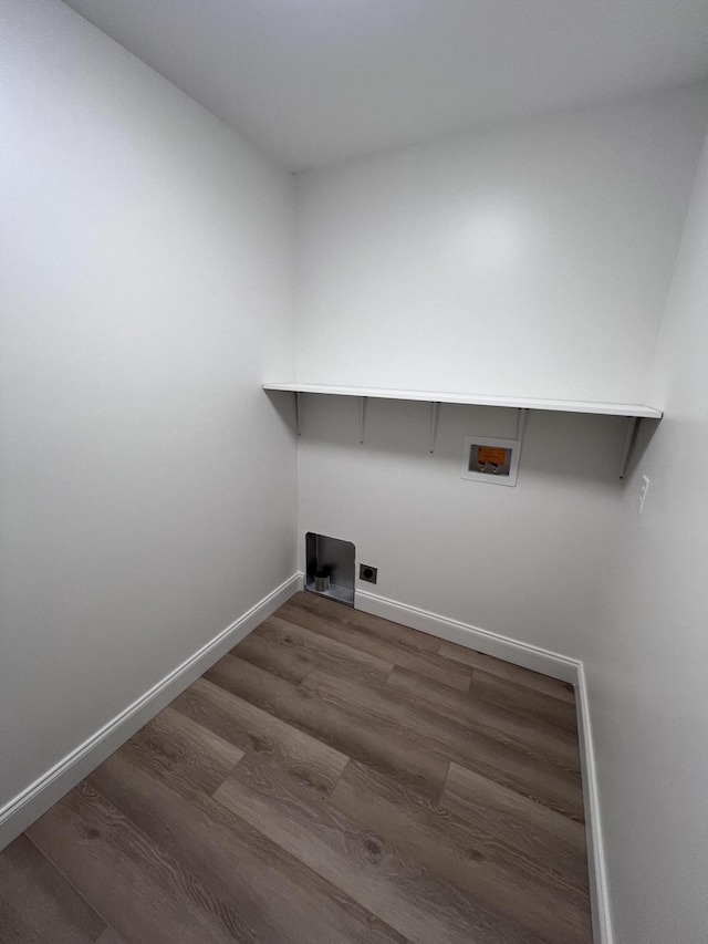 laundry area with dark wood-style floors, hookup for a washing machine, hookup for an electric dryer, laundry area, and baseboards