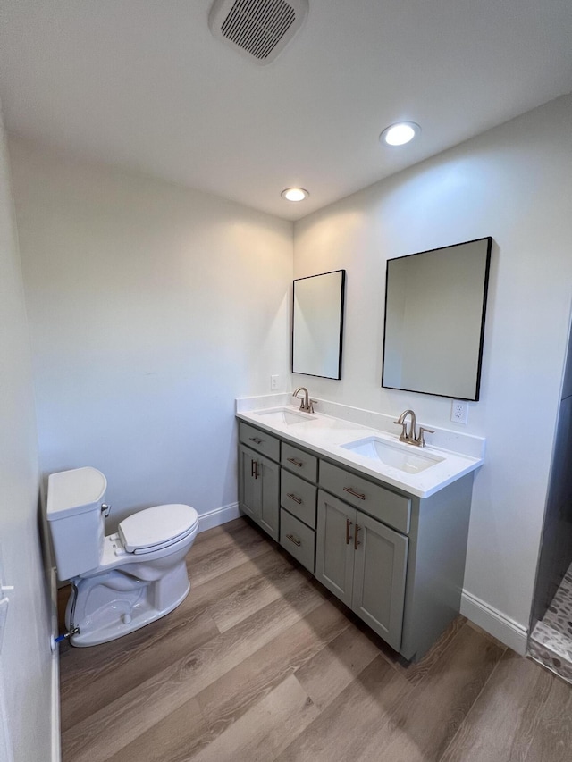 bathroom featuring hardwood / wood-style flooring, vanity, and toilet