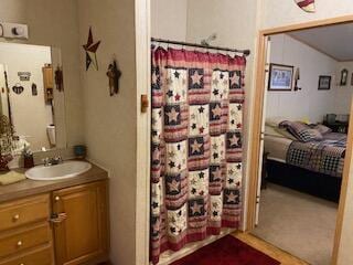 bathroom featuring vanity and a shower with shower curtain