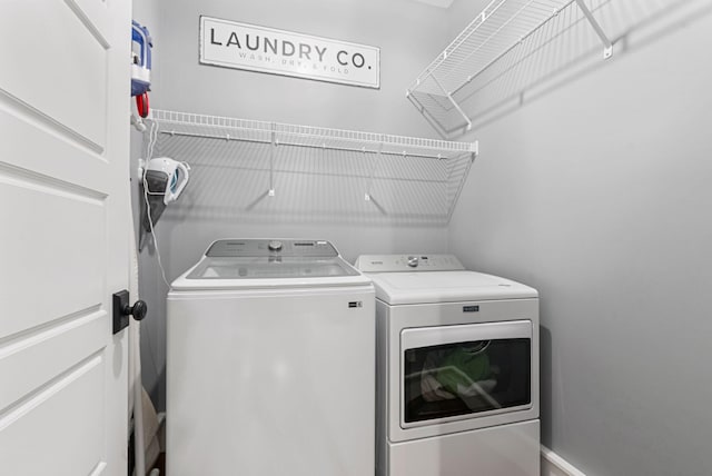 clothes washing area featuring separate washer and dryer