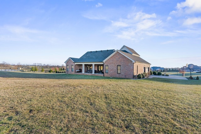 back of property featuring a yard and a water view